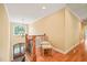 Hallway with chandelier and a wrought iron staircase, leading to the front entry doors at 10540 Byrum Woods Dr, Raleigh, NC 27613