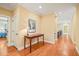 Hallway featuring a wood floor, table lamp and access to other rooms at 10540 Byrum Woods Dr, Raleigh, NC 27613