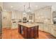 Stylish kitchen featuring a center island, custom cabinetry, and modern fixtures at 10540 Byrum Woods Dr, Raleigh, NC 27613