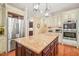 Island kitchen with granite countertops, stainless appliances and hanging pendant lights at 10540 Byrum Woods Dr, Raleigh, NC 27613