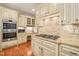 Gourmet kitchen with custom cabinets, granite counters, and gas cooktop at 10540 Byrum Woods Dr, Raleigh, NC 27613