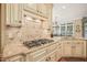 Kitchen featuring granite countertops, tile backsplash, and gas stovetop at 10540 Byrum Woods Dr, Raleigh, NC 27613