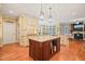 Open concept kitchen with island, pendant lighting, and hardwood floors at 10540 Byrum Woods Dr, Raleigh, NC 27613