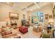 Comfortable living room featuring coffered ceilings and large windows for plenty of sunlight at 10540 Byrum Woods Dr, Raleigh, NC 27613