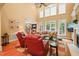 Bright living room boasts large windows, fireplace, and hardwood floors at 10540 Byrum Woods Dr, Raleigh, NC 27613