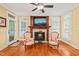 Living room featuring a fireplace, TV, two chairs and ample natural light at 10540 Byrum Woods Dr, Raleigh, NC 27613