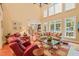 Elegant living room with high ceilings, plush seating, and pool views at 10540 Byrum Woods Dr, Raleigh, NC 27613