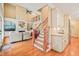 Open living area with a grand staircase, fireplace, and adjacent kitchen at 10540 Byrum Woods Dr, Raleigh, NC 27613