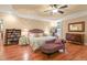 Bright main bedroom with hardwood floors, tray ceiling, and decorative furnishings at 10540 Byrum Woods Dr, Raleigh, NC 27613