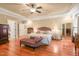 Open and airy main bedroom with hardwood floors, tray ceiling, and sitting area at 10540 Byrum Woods Dr, Raleigh, NC 27613