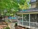 View of the screened porch showing backyard pool with slide and lounge chairs at 10540 Byrum Woods Dr, Raleigh, NC 27613