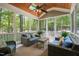 Inviting screened-in porch with plush outdoor seating and views of the wooded backyard at 10540 Byrum Woods Dr, Raleigh, NC 27613