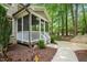 Screened porch adjacent to a manicured yard and walkway at 10540 Byrum Woods Dr, Raleigh, NC 27613
