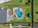An aerial view of a private backyard oasis with a pool, playset, outdoor seating, and lush landscaping at 109 Obsidian Dr, Holly Springs, NC 27540