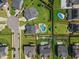 Aerial view showcasing a backyard swimming pool, playground, and manicured landscaping at 109 Obsidian Dr, Holly Springs, NC 27540