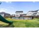 Backyard featuring a swimming pool and slide, surrounded by a well-maintained lawn at 109 Obsidian Dr, Holly Springs, NC 27540