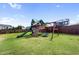 Backyard playset features swings, slide, and climbing area, perfect for Gathering fun and recreation at 109 Obsidian Dr, Holly Springs, NC 27540