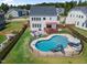 Aerial view of a home's backyard showing the deck, pool, firepit and fencing at 109 Obsidian Dr, Holly Springs, NC 27540
