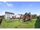 Spacious backyard with a pool and playset provides an ideal space for outdoor activities at 109 Obsidian Dr, Holly Springs, NC 27540