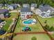 Aerial view of the beautiful backyard with a private pool, slide, playground, patio and firepit at 109 Obsidian Dr, Holly Springs, NC 27540