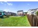 Large, grassy backyard features a pool, playground, and outdoor entertainment areas at 109 Obsidian Dr, Holly Springs, NC 27540