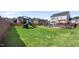 Expansive backyard featuring a swimming pool, playground, and lush green lawn at 109 Obsidian Dr, Holly Springs, NC 27540