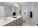 Bright bathroom featuring double sinks, a separate toilet, shower-tub combo, and natural light at 109 Obsidian Dr, Holly Springs, NC 27540