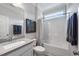 Neutral bathroom with a single sink vanity, shower and bath combination, and modern fixtures at 109 Obsidian Dr, Holly Springs, NC 27540