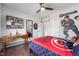 A bedroom features hardwood floors, a ceiling fan, and a well-lit desk at 109 Obsidian Dr, Holly Springs, NC 27540