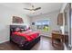 A bedroom features a full-sized bed, ceiling fan, hardwood floors, and a bright window at 109 Obsidian Dr, Holly Springs, NC 27540