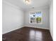 This bedroom has a great view from the large window with natural light and hardwood floors at 109 Obsidian Dr, Holly Springs, NC 27540