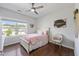 Charming bedroom features a ceiling fan, wood floors, and a bright window at 109 Obsidian Dr, Holly Springs, NC 27540