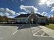 Well-maintained community clubhouse exterior with ample parking and attractive landscaping at 109 Obsidian Dr, Holly Springs, NC 27540