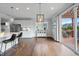 Bright dining area adjacent to kitchen, with chairs, pendant lighting and sliding glass door to the deck at 109 Obsidian Dr, Holly Springs, NC 27540