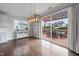 Bright dining area features hardwood floors, modern lighting, and sliding glass doors to a pergola-covered deck at 109 Obsidian Dr, Holly Springs, NC 27540