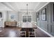 Spacious dining room with a large wooden table, designer light fixture, and stylish decor at 109 Obsidian Dr, Holly Springs, NC 27540