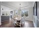 Bright dining room features a large table, modern light fixture, and access to the living area at 109 Obsidian Dr, Holly Springs, NC 27540