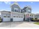Charming two-story home with a well-maintained lawn, two car garage, and inviting front porch at 109 Obsidian Dr, Holly Springs, NC 27540