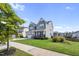 Well-manicured lawn and landscaping highlight this attractive two-story home with a two car garage at 109 Obsidian Dr, Holly Springs, NC 27540