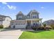 Charming two-story home with a well-maintained lawn, two car garage, and inviting front porch at 109 Obsidian Dr, Holly Springs, NC 27540