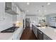Modern kitchen featuring white cabinets, stainless steel appliances, subway tile backsplash, and kitchen island at 109 Obsidian Dr, Holly Springs, NC 27540