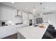 Modern kitchen featuring white cabinets, stainless steel appliances, an island, and pendant lighting at 109 Obsidian Dr, Holly Springs, NC 27540