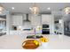 Bright kitchen with quartz island, stainless steel appliances, and pendant lights above breakfast bar at 109 Obsidian Dr, Holly Springs, NC 27540