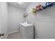 Functional laundry room equipped with washer, dryer, and shelving for organization at 109 Obsidian Dr, Holly Springs, NC 27540