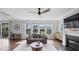 Bright living room with large windows overlooking backyard and fireplace with television at 109 Obsidian Dr, Holly Springs, NC 27540