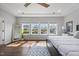 Bright main bedroom with tray ceiling, large windows overlooking the back yard, and hardwood floors at 109 Obsidian Dr, Holly Springs, NC 27540