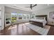 Bright main bedroom with tray ceiling, large windows, hardwood floors and ensuite bath at 109 Obsidian Dr, Holly Springs, NC 27540