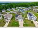 Aerial view of neighborhood, homes with solar panels, and lush green landscaping at 1104 Arden Trace Ct, Fuquay Varina, NC 27526