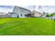 Large, private backyard with lush grass, fenced perimeter, and patio area at 1104 Arden Trace Ct, Fuquay Varina, NC 27526