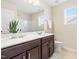 Bathroom vanity featuring a sink, mirror, and a window providing natural light at 1104 Arden Trace Ct, Fuquay Varina, NC 27526